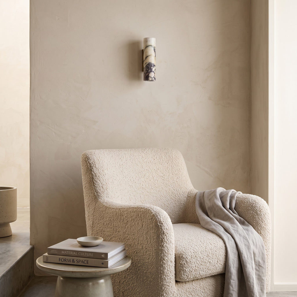 Marble Cylinder Wall Light – H 24cm in a quiet reading corner above a boucle armchair