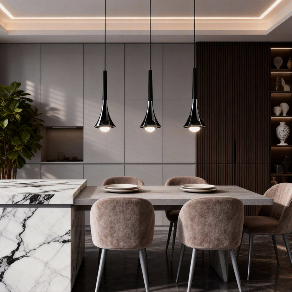 Three modern matte black teardrop pendant lights hanging over a marble kitchen island and dining table.