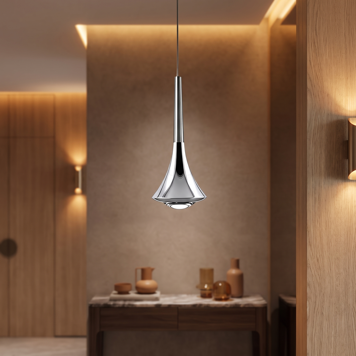 Modern chrome teardrop pendant light with a sleek iron finish and integrated 9W LED, hanging in a contemporary interior.