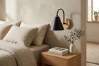 Nordic Wood Wall Light in black above a bedside table in a serene bedroom