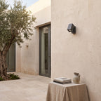 Outdoor Spotlight Wall Light – in a courtyard with olive trees and limestone walls