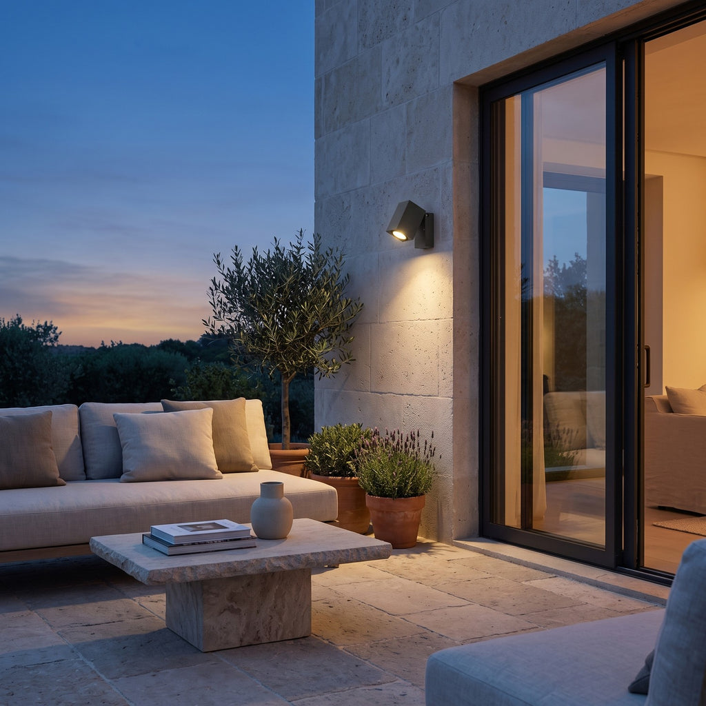 Outdoor Spotlight Wall Light – in a stone terrace beside large glass doors at dusk