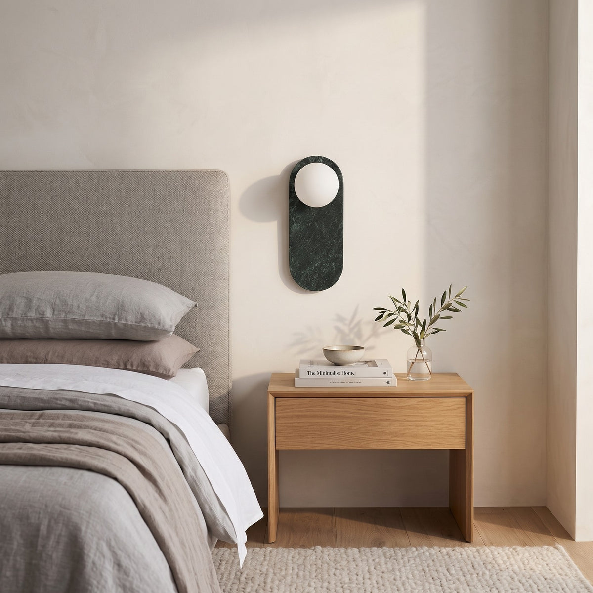 Oval Marble Wall Light – Dark Green AStyle in a serene bedroom beside an upholstered headboard and oak nightstand