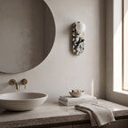 Oval Marble Wall Light – Black White AStyle in a spa-like bathroom beside a large round mirror and stone vanity