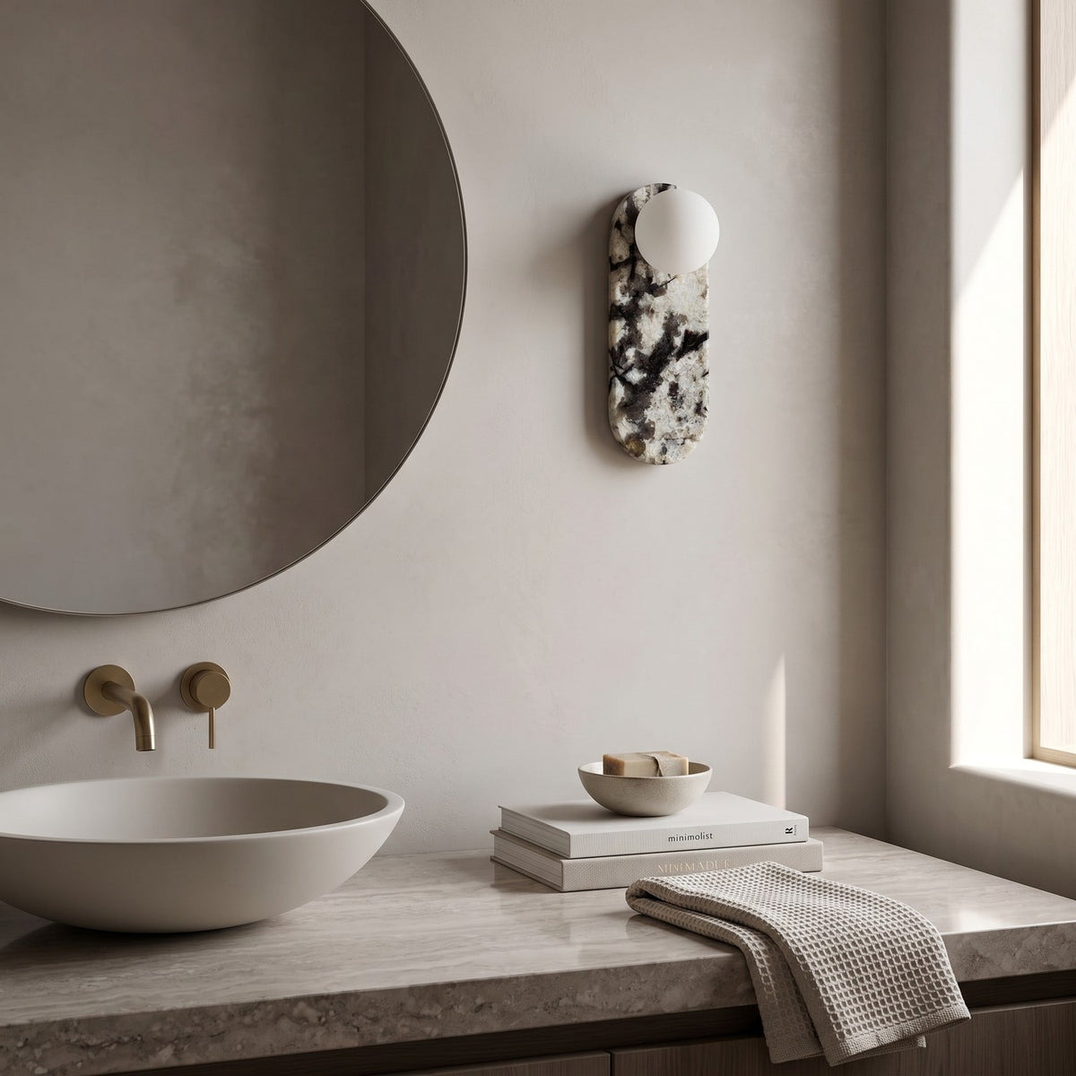 Oval Marble Wall Light – Black White AStyle in a spa-like bathroom beside a large round mirror and stone vanity