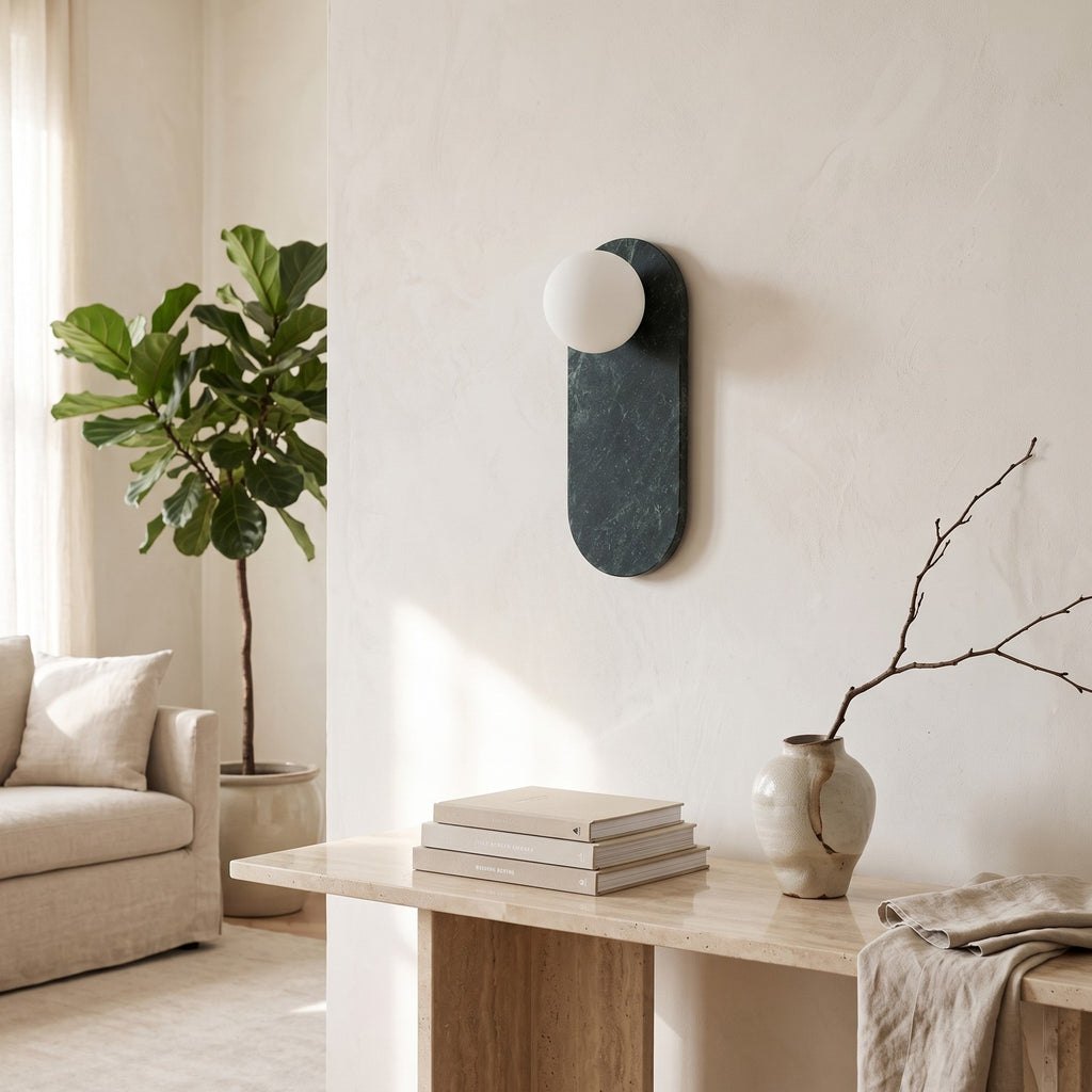 Oval Marble Wall Light – Dark Green AStyle in a bright living room above a travertine console