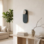 Oval Marble Wall Light – Dark Green AStyle in a bright living room above a travertine console