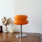 Retro orange glass table lamp with a rounded, two-tier shade on a polished chrome base, 29cm tall.