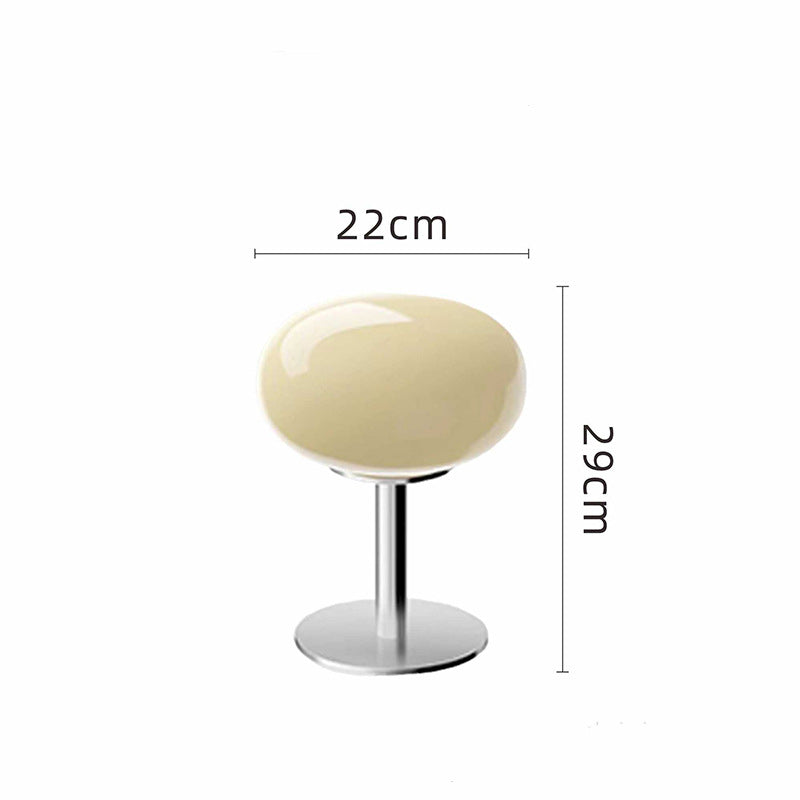Retro 70s space age table lamp with a glossy cream glass shade and polished chrome base, 29cm tall.