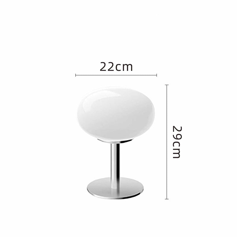 Retro 70s space age table lamp with a white glass shade and polished chrome base, measuring 29cm high and 22cm wide.