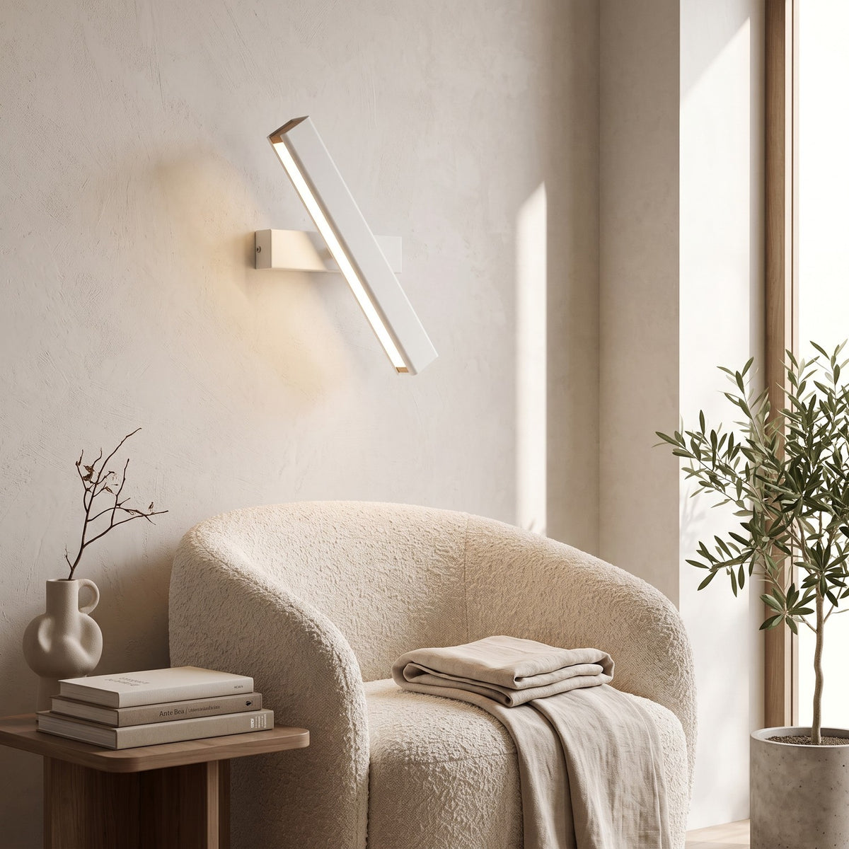 Rotatable LED Wall Light – White in a quiet reading corner above a boucle armchair
