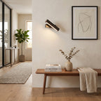 Rotatable LED Wall Light – Black in an entrance hall above a slim walnut bench