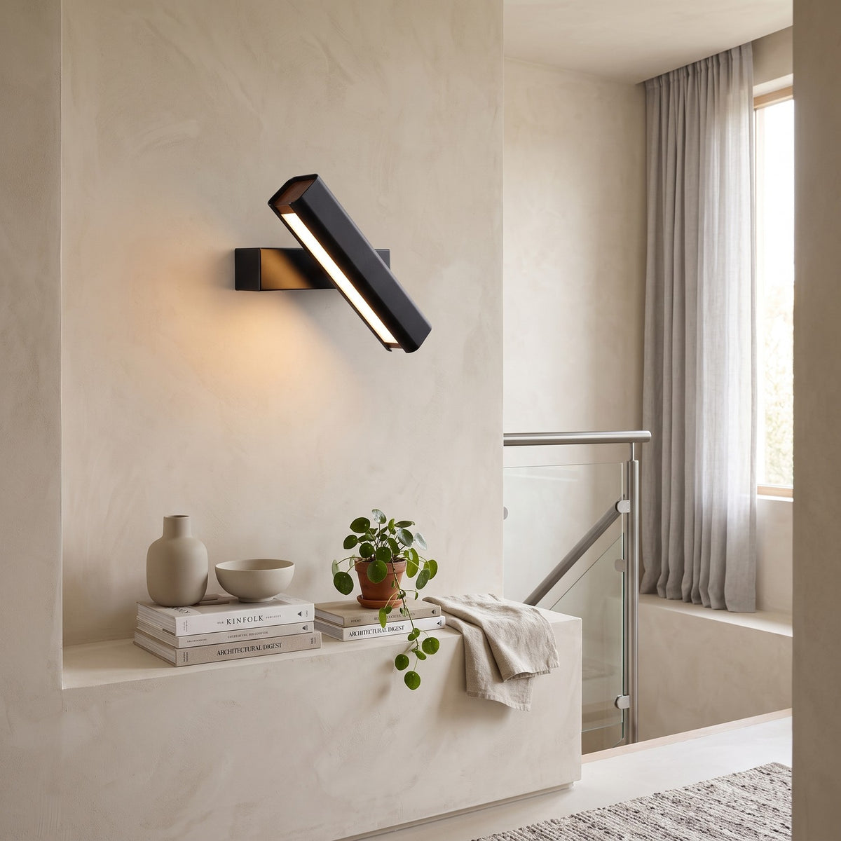 Rotatable LED Wall Light – Black in a staircase landing with limewashed walls