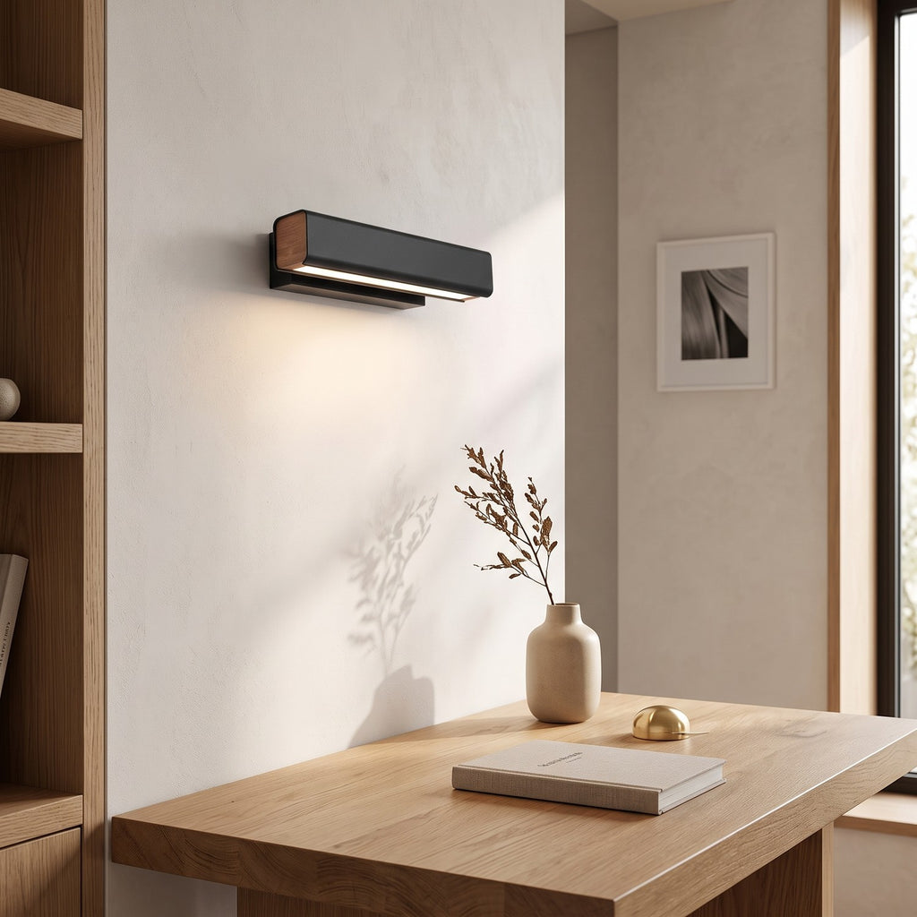 Rotatable LED Wall Light – Black in a calm home office above a solid oak desk