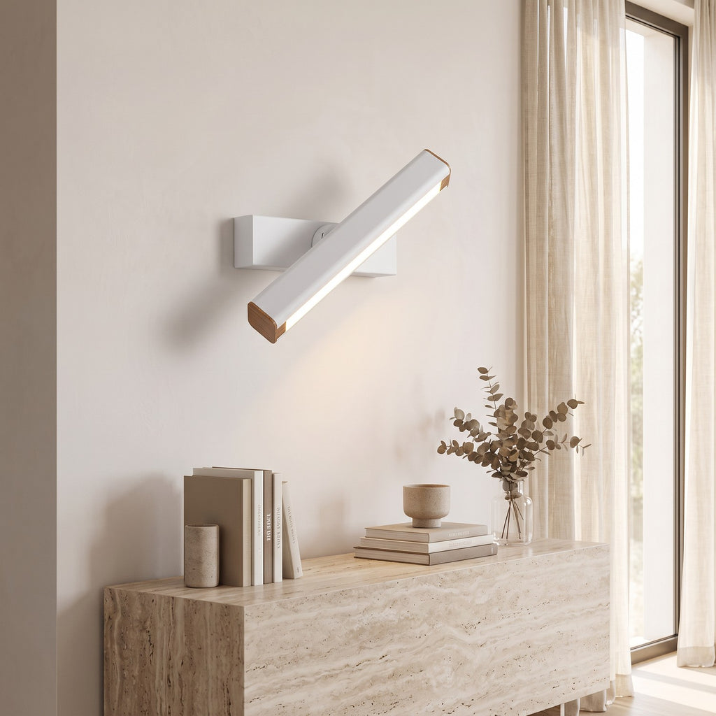 Rotatable LED Wall Light – White in a bright living room above a travertine console