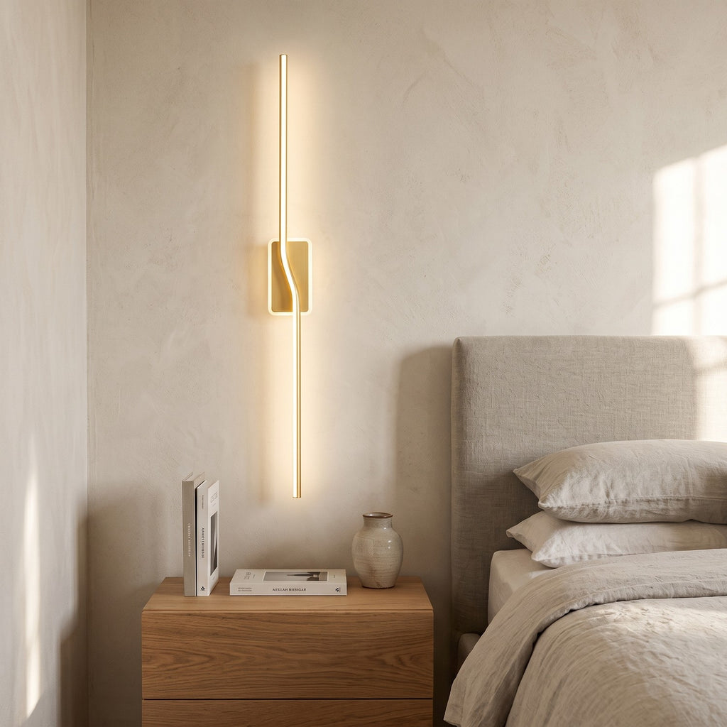 Slim Linear LED Wall Light – Gold in a serene bedroom beside an upholstered headboard and oak nightstand