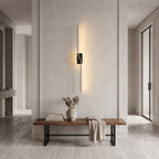 Slim Linear LED Wall Light – Black in an entrance hall above a slim walnut bench