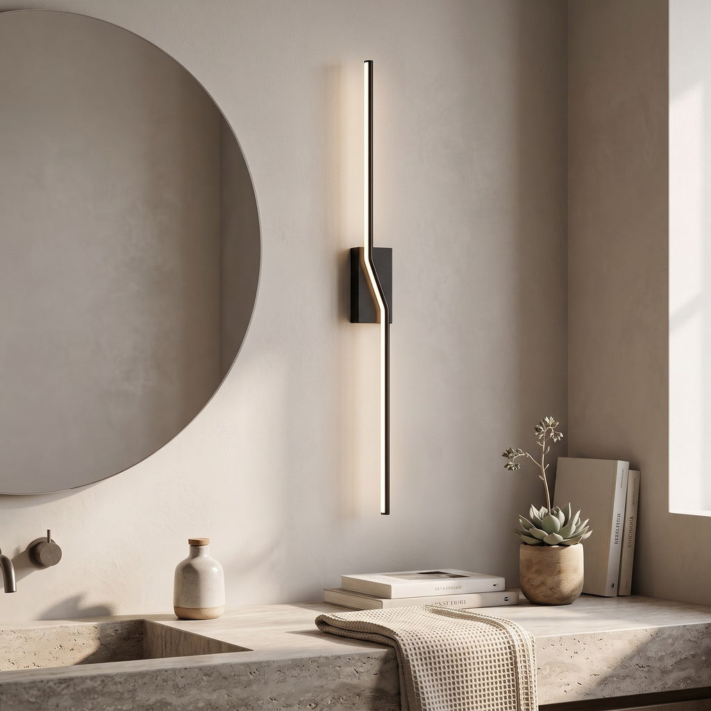 Slim Linear LED Wall Light – Black in a spa-like bathroom beside a large round mirror and stone vanity