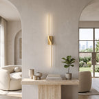 Slim Linear LED Wall Light – Gold in a bright living room above a travertine console