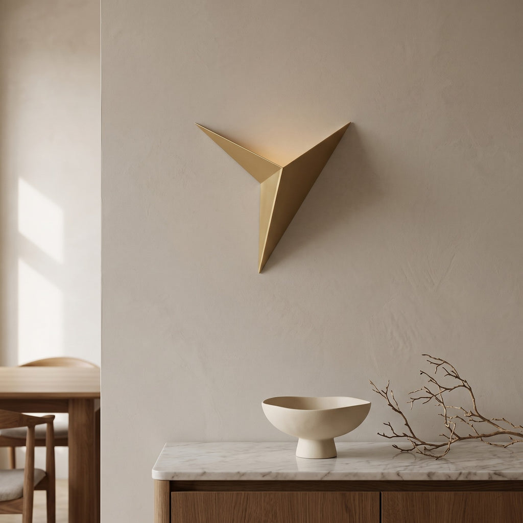 Triangle LED Wall Light in gold above a marble sideboard in an elegant dining room