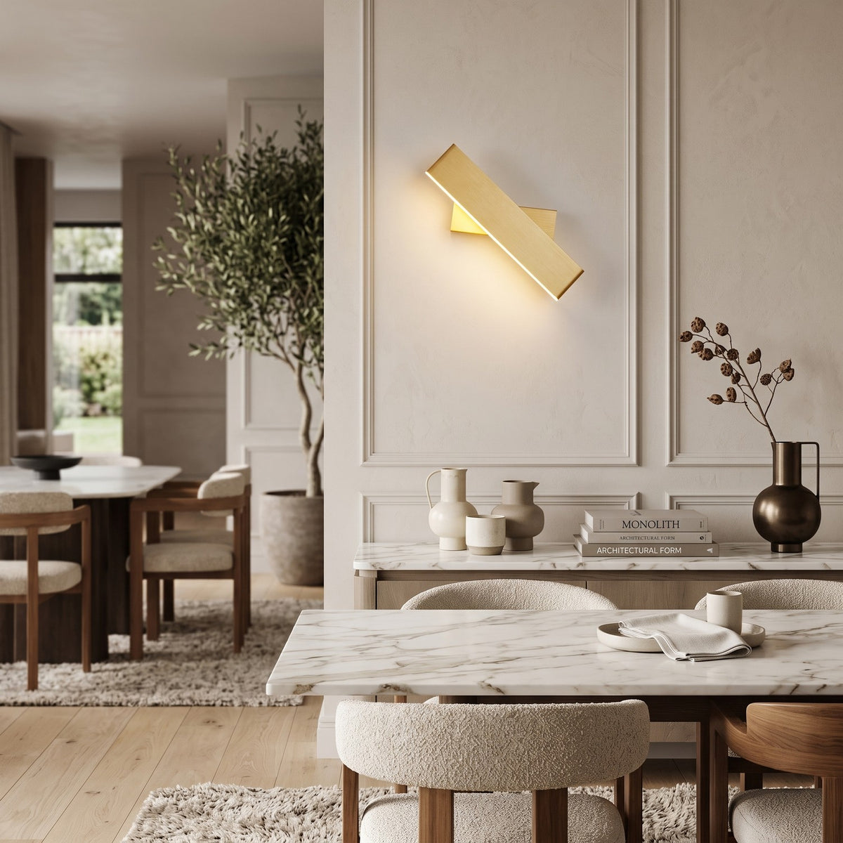 Up Down LED Wall Light – Gold in an elegant dining room above a marble sideboard
