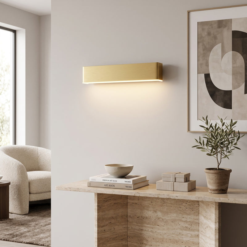 Up Down LED Wall Light – Gold in a bright living room above a travertine console