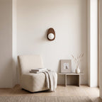 Walnut Wood Wall Light in a quiet reading corner above a boucle armchair