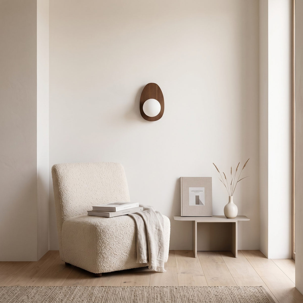 Walnut Wood Wall Light in a quiet reading corner above a boucle armchair