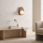 Walnut Wood Wall Light in a bright living room above a travertine console
