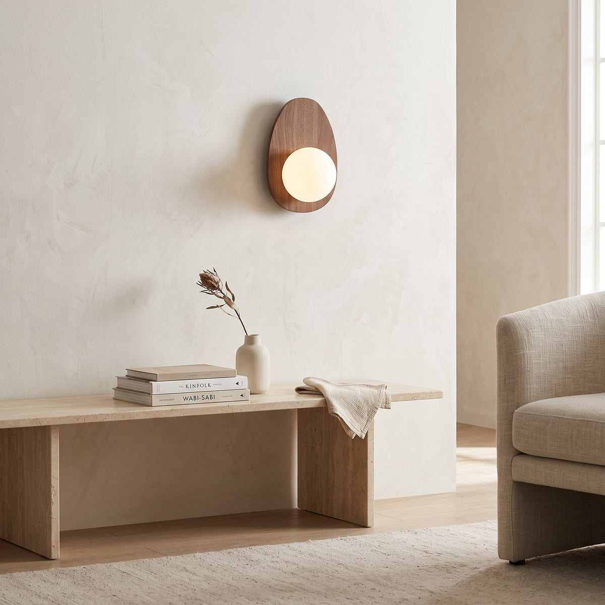 Walnut Wood Wall Light in a bright living room above a travertine console