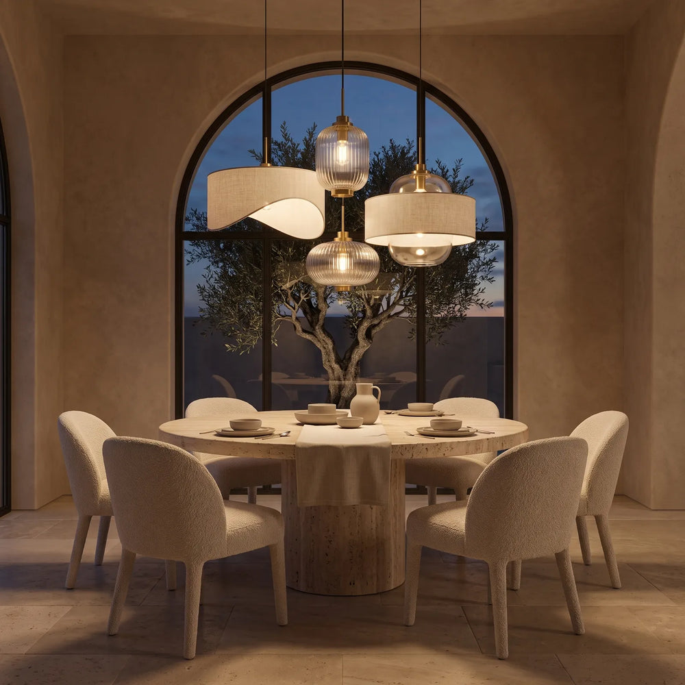 Linen and glass pendant lights above a travertine dining table