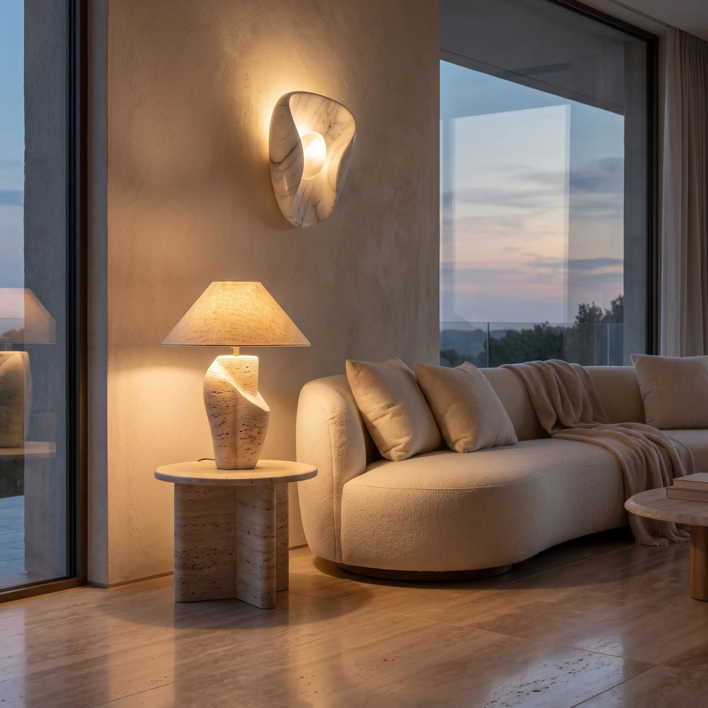 Travertine table lamp and marble wall light in a living room