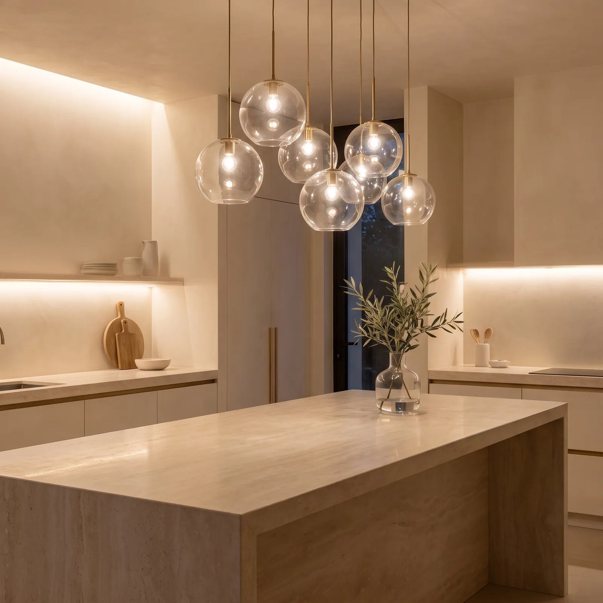 Glass globe pendant lights over a stone kitchen island
